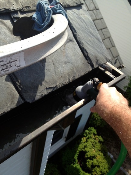 Marc’s on the Glass cleaning gutters and flushing downspouts in richmond virginia