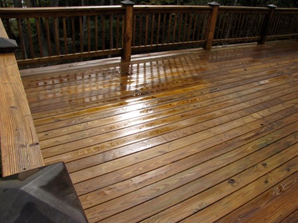 Marc’s on the Glass Power washing old deck with black and grey coloring, severe weathering, fully restored in Richmond, VA